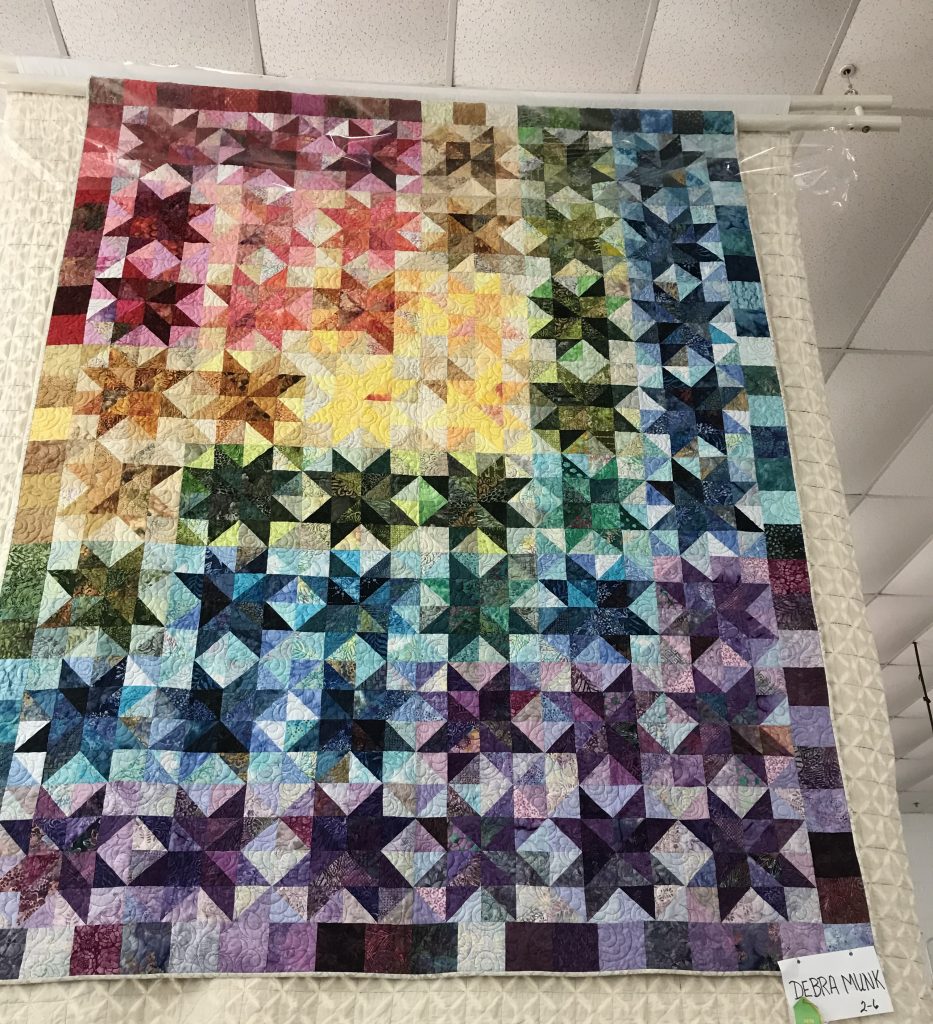 A rainbow half square triangle quilt by Debra Munk, which won a prize 